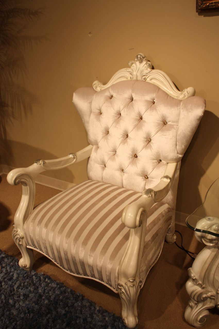 Luxury furniture often includes armchairs upholstered in silk with tufted details.